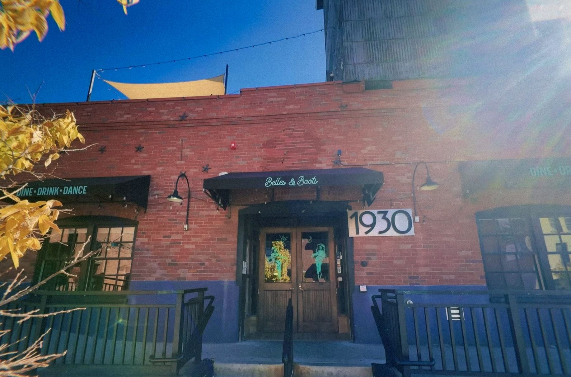 Red brick building with belles and boots sign